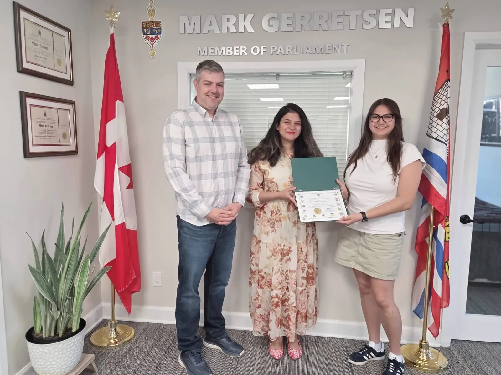 DoorStep Dental founders receiving a Certificate of Recognition at the constituency office of the Member of Parliament for Kingston and the Islands