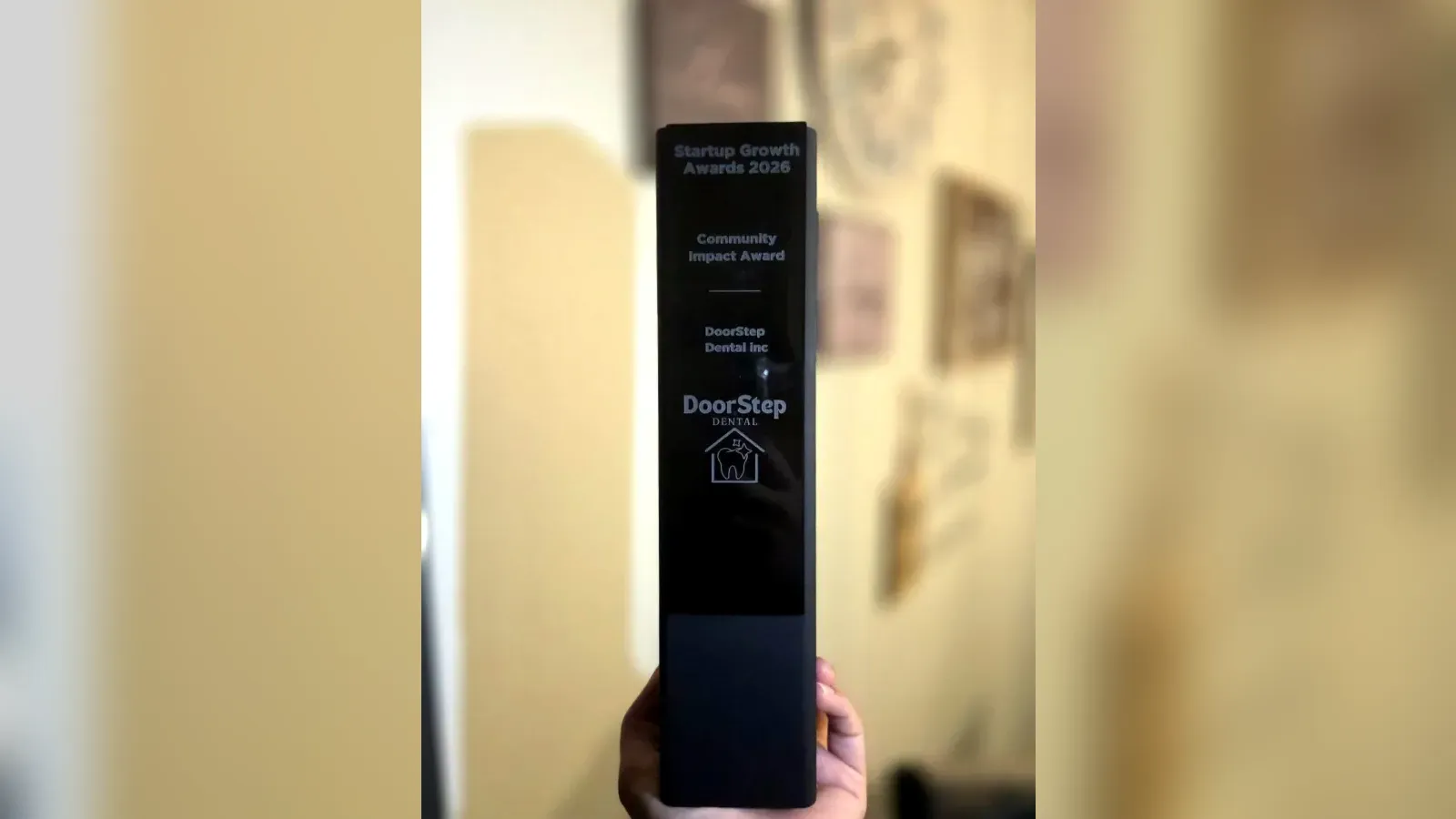 Community Impact Award trophy from the Startup Growth Awards 2026 presented to DoorStep Dental Inc, a mobile dental hygiene provider in Ontario